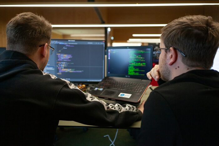 IT professionals collaborating at a workstation